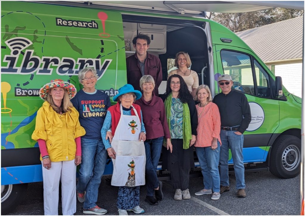 Group of people standing outside a bookmobile van